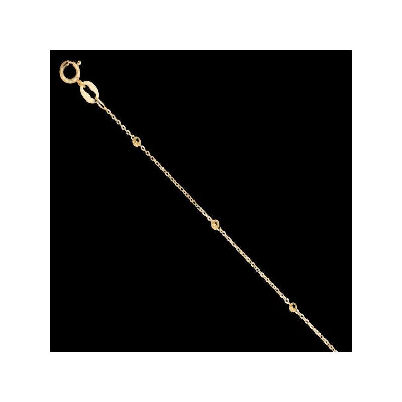 Ankle chain with small gold balls.